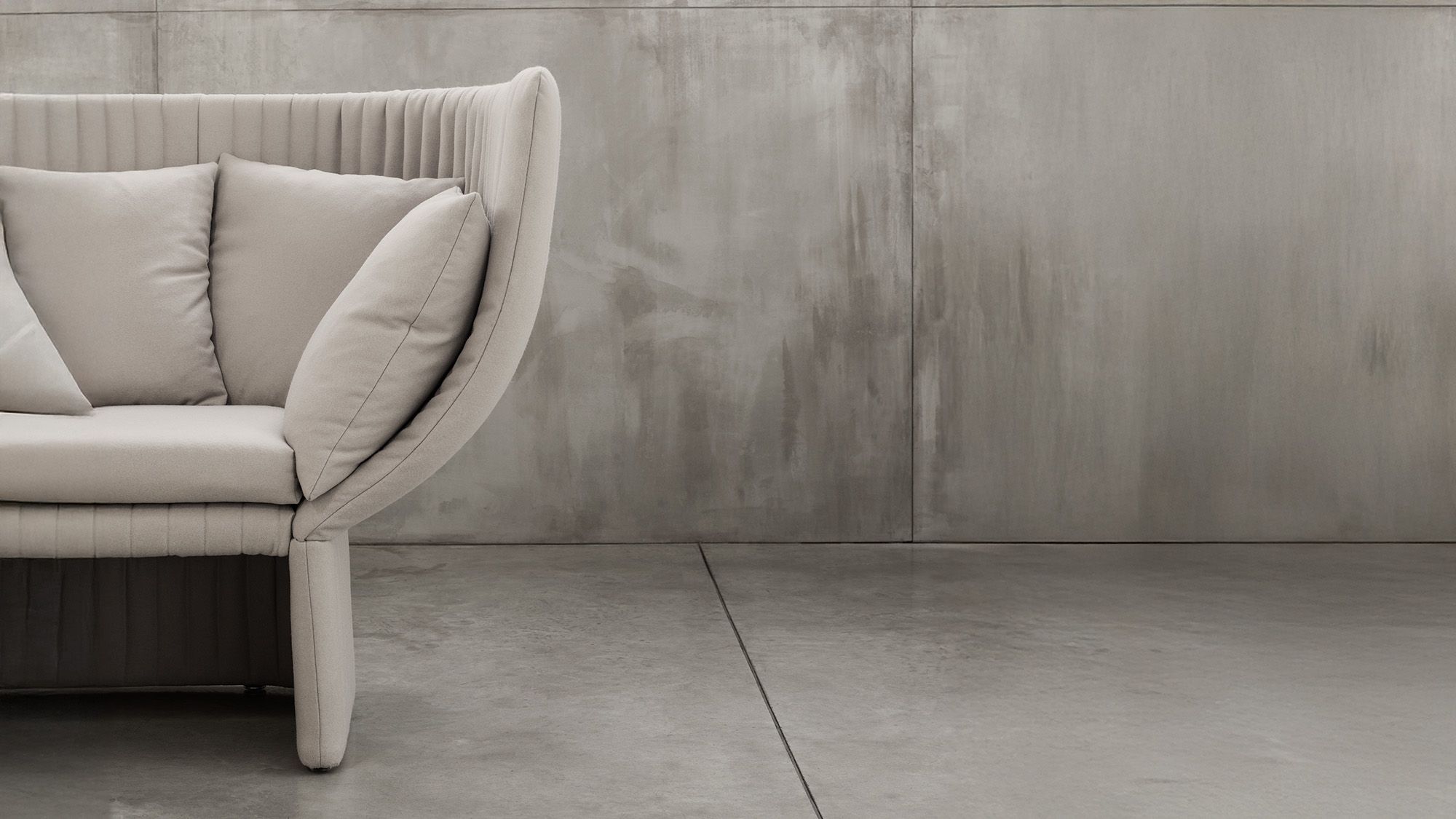 High-back acoustic office sofa detail highlighting the enveloping upholstered design that enhances privacy and acoustic comfort.