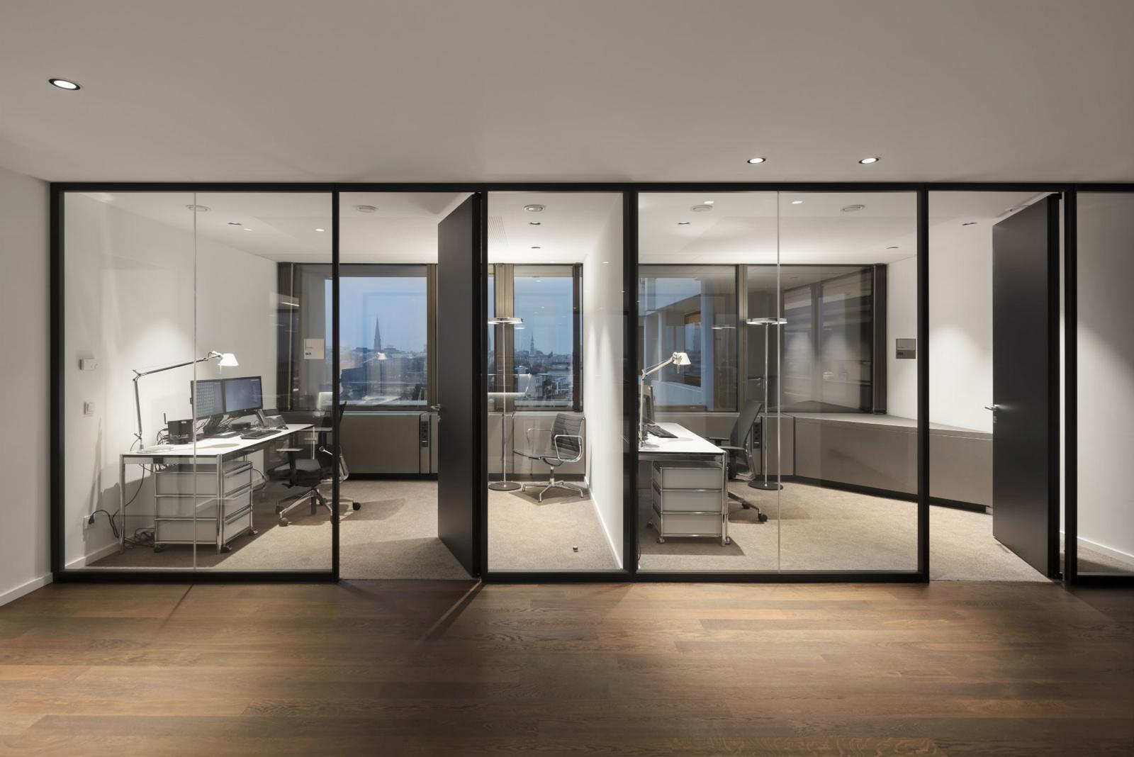 Open-plan workplace enhanced by modular demountable partitioning that defines rooms, improves acoustics, and supports future layout changes.