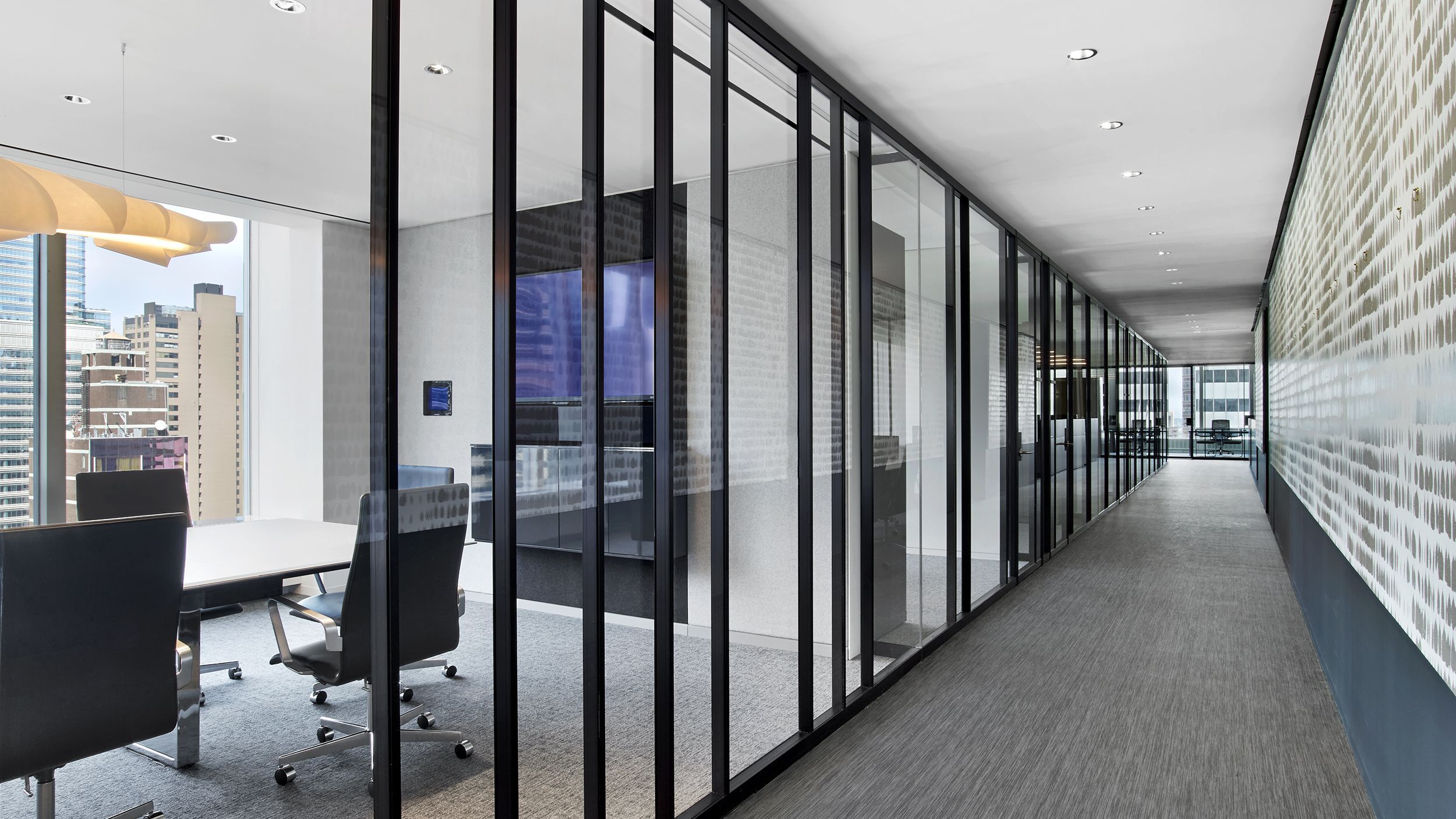 Detail of a custom dark blue anodized profile on Ultralight demountable glass partitions, showcasing the elegance of anodic oxidation.