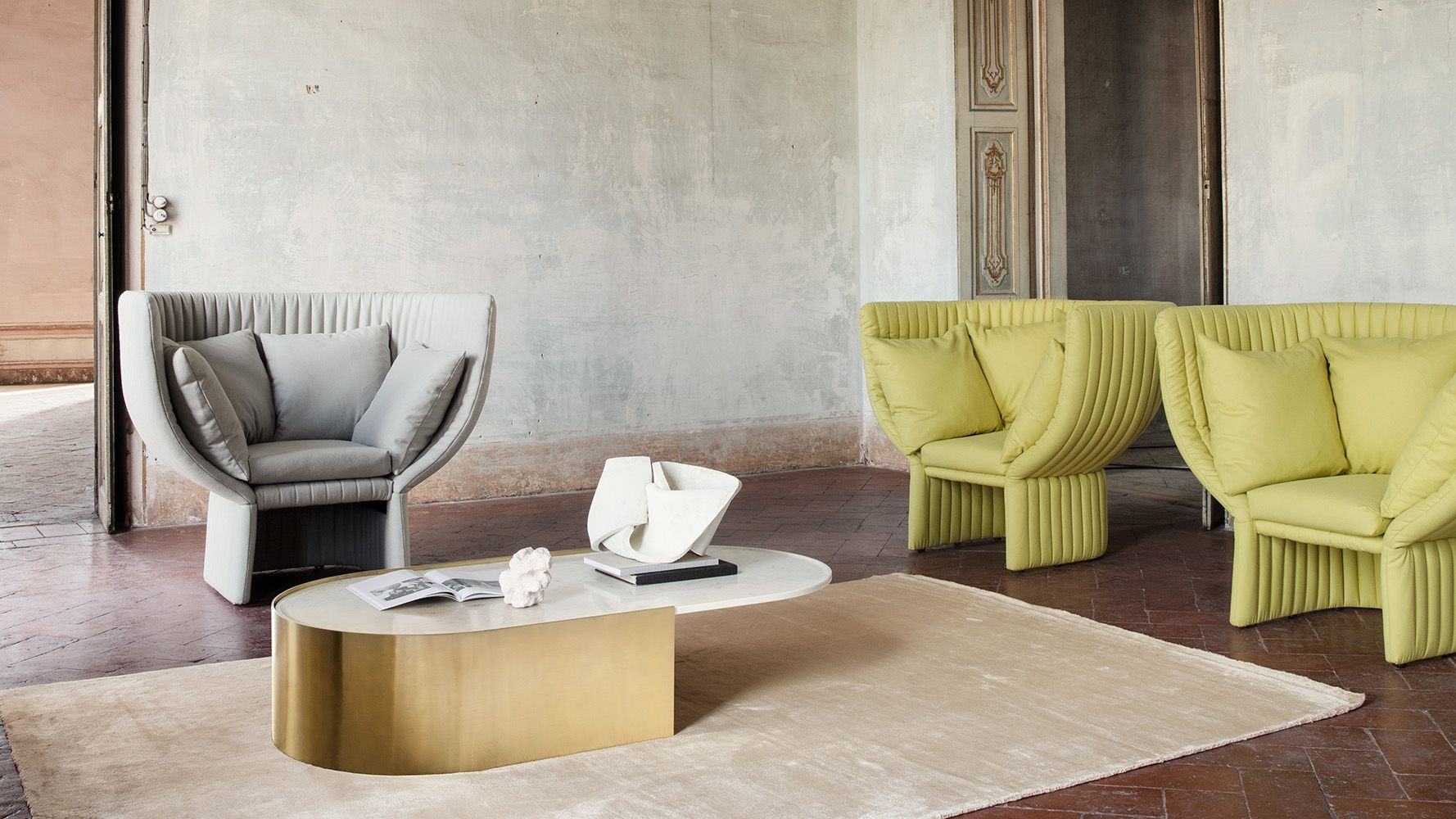 Ghisolfa acoustic sofa designed by Raffaella Mangiarotti, featuring a sinuous profile and fluted detailing that provides sound harmony and privacy near a modern executive desk